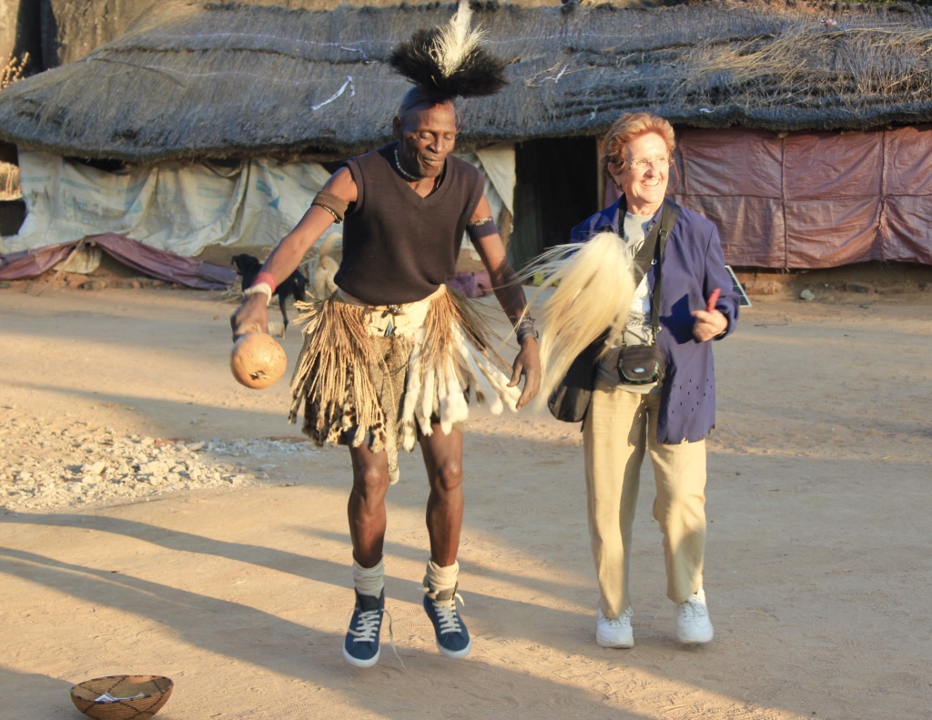 A villager dancing with a guest at the homestead