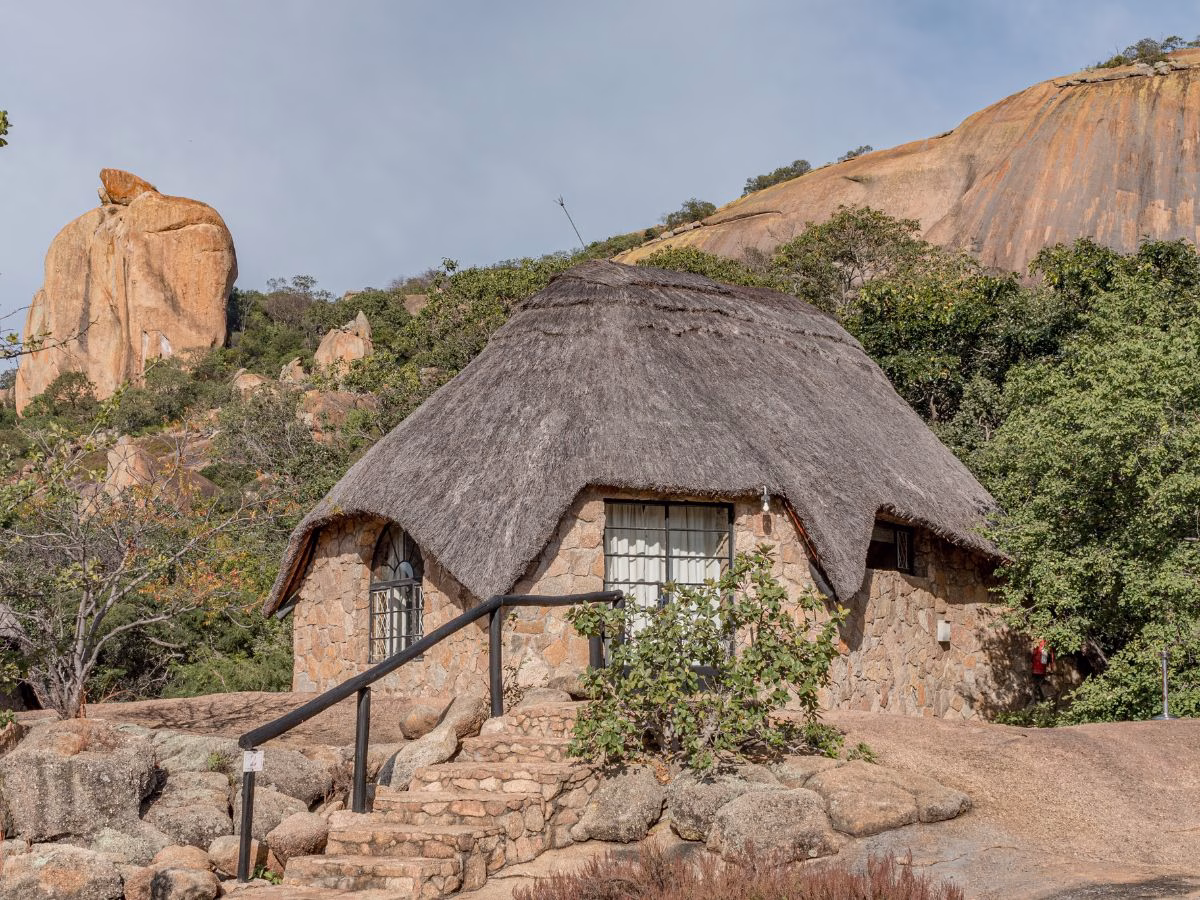 Thatched stone bush chalet exterior at Matobo Hills Lodge