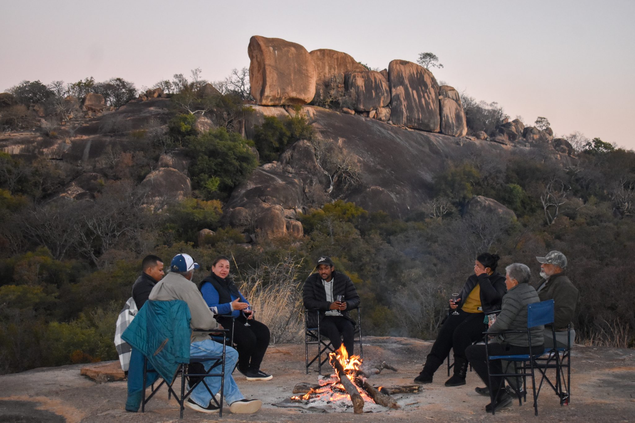 Outdoor dining at sunset at Matobo Hills Lodge, Zimbabwe
