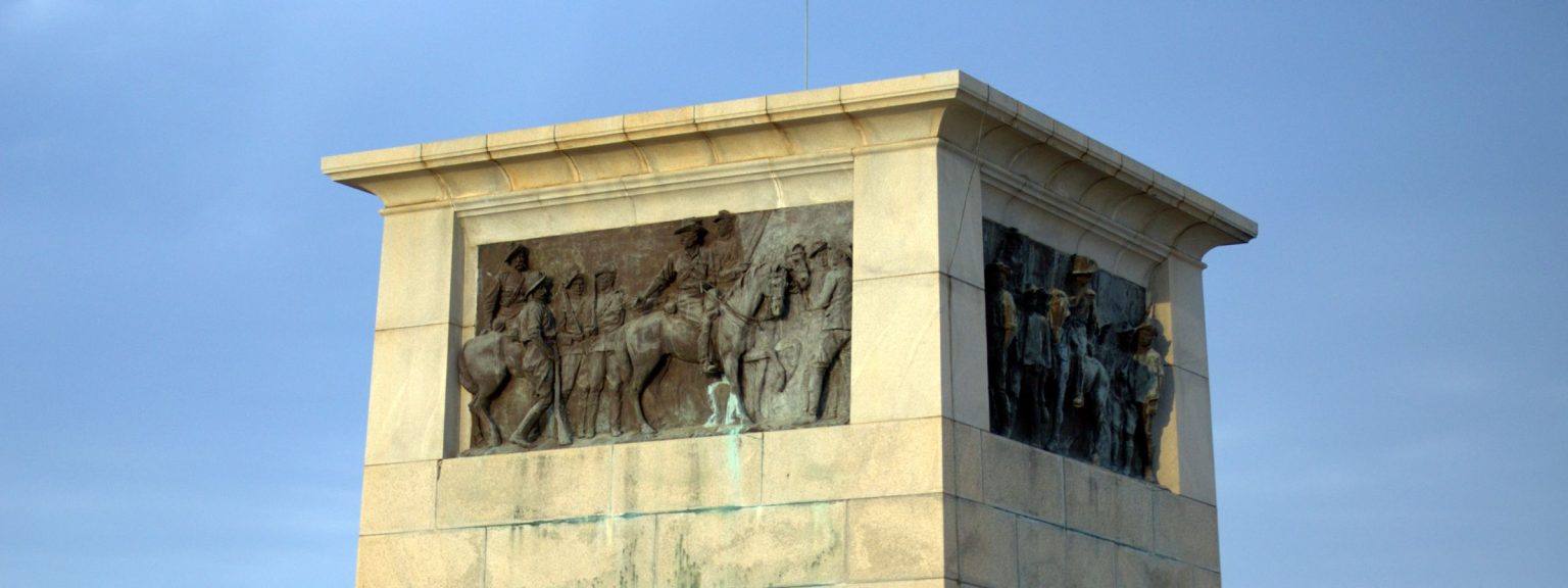 The Shangani Memorial on World’s View: a stone block carrying bronze relief panels