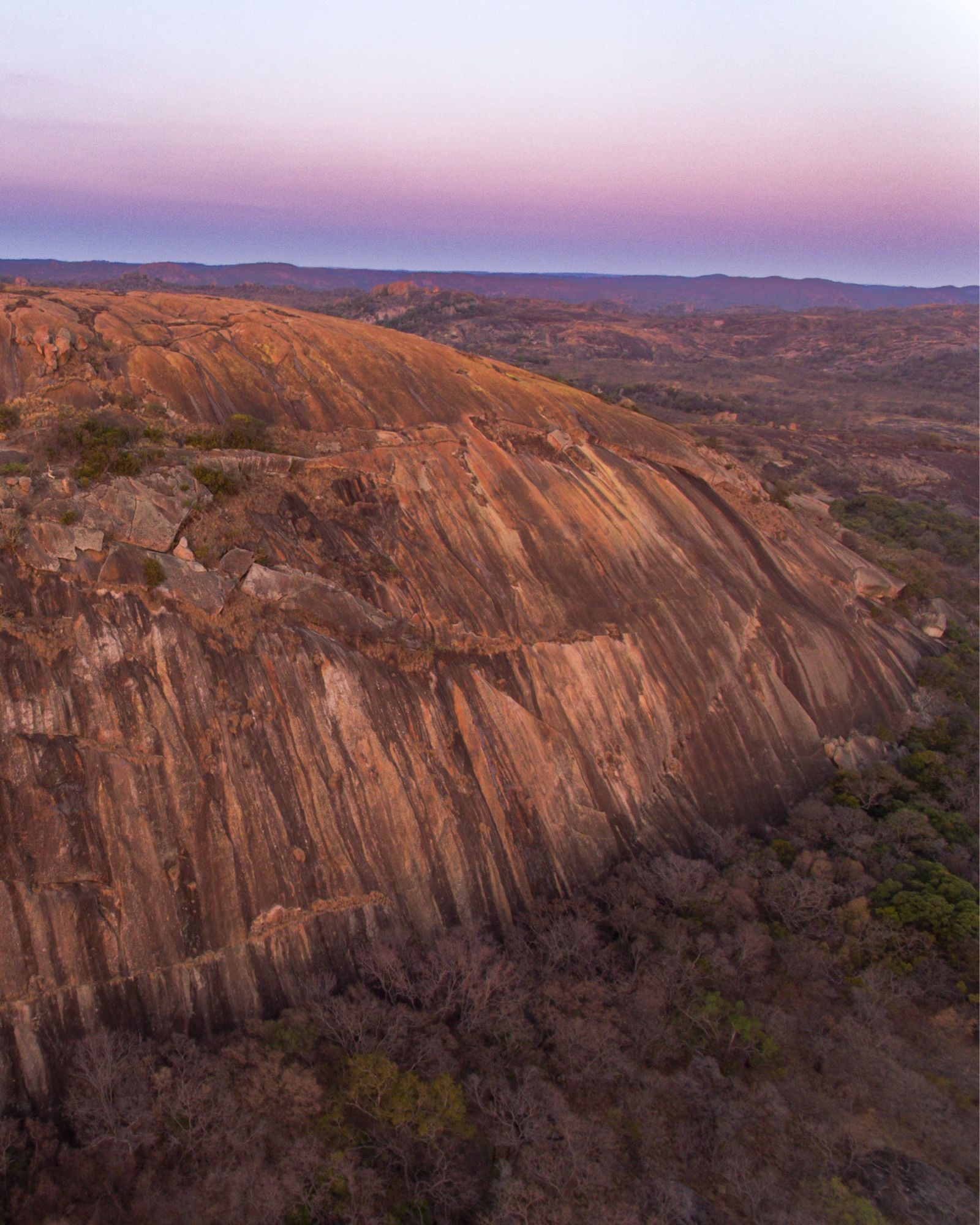 Sunrise over a whaleback granite dome in Matobo
