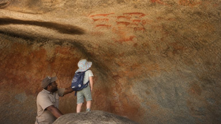 Guide showing San rock art in the Matobo Hills